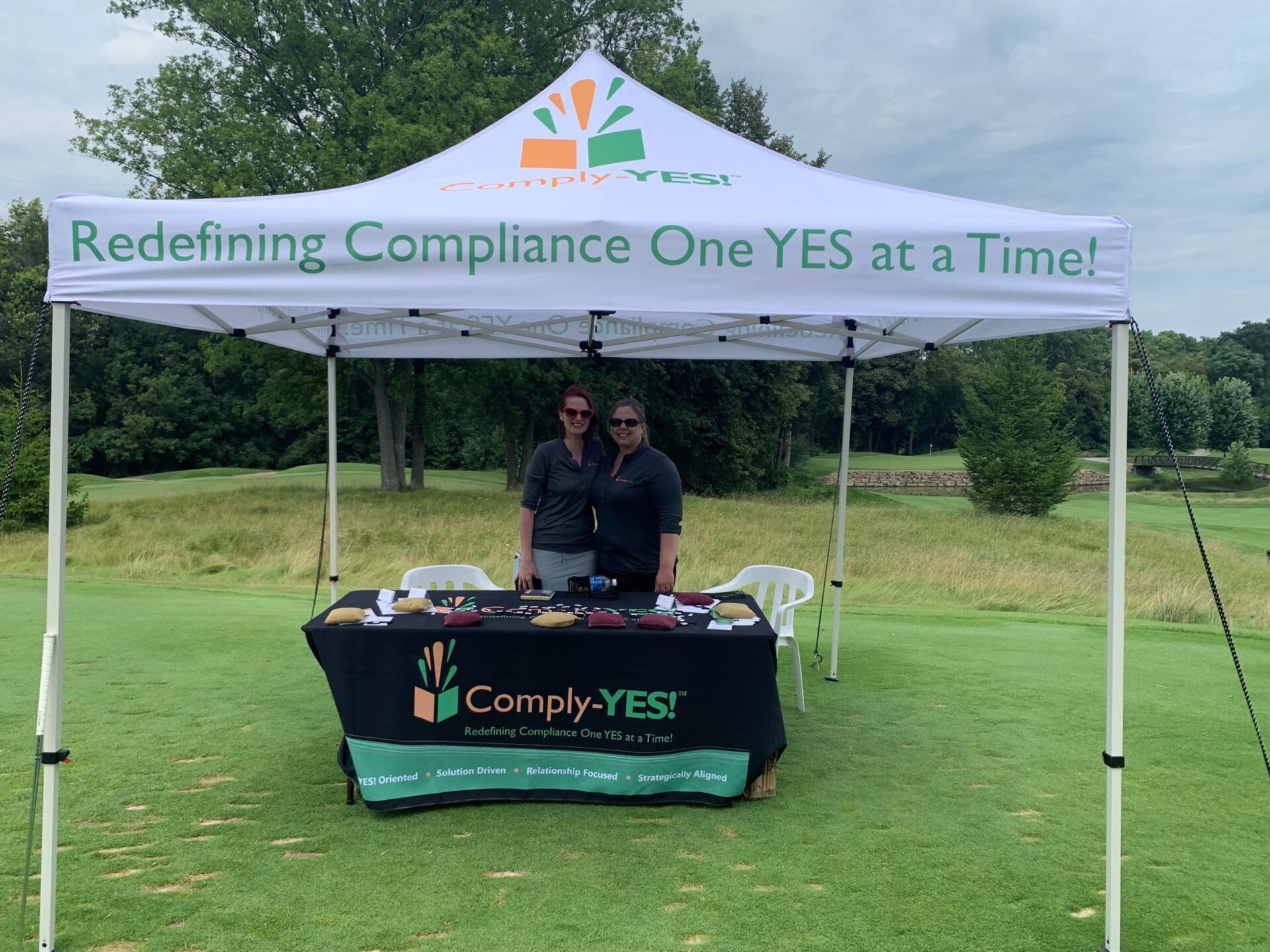 melissa osborn and sara cottle at an outing tent